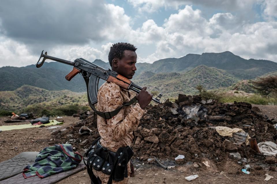 A member of the Afar Special Forces stands in front of the debris of a house in the outskirts of the village of Bisober, Tigray Region, Ethiopia. (Eduardo Soteras/AFP via Getty Images)