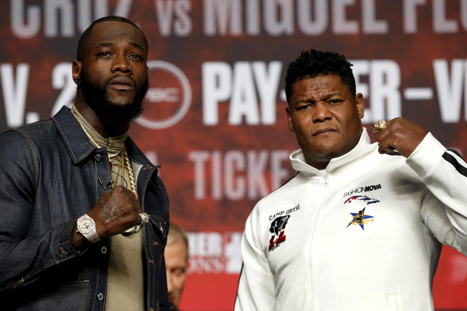 WBC heavyweight champion Deontay Wilder, left, poses with Luis Ortiz during a final news conference at MGM Grand Garden Arena in Las Vegas Wednesday, Nov. 20, 2019. The boxers will have a rematch at the arena on Saturday, Nov. 23, 2019. (Steve Marcus/Las Vegas Sun via AP)