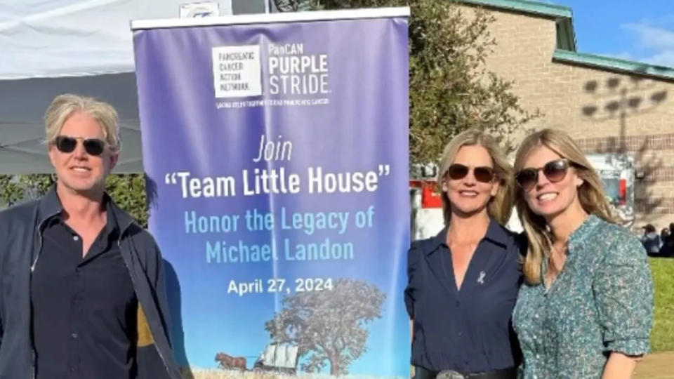 Leslie Landon Matthews with her siblings in front of a sign for the 50th anniversary of Little House on the Prairie