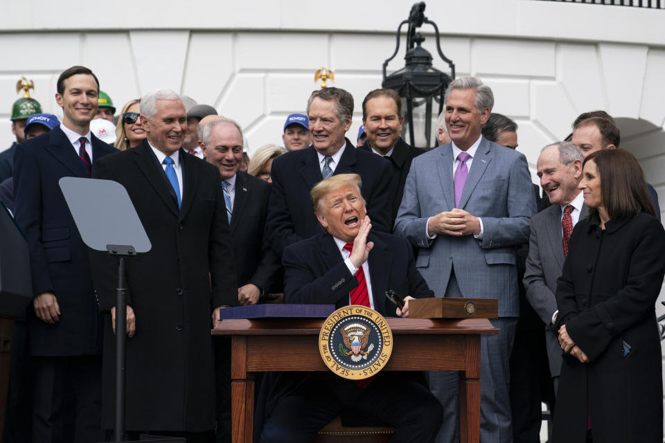 President Donald Trump speaks before signing a new North American trade agreement with Canada and Mexico, during an event at the White House, Wednesday, Jan. 29, 2020, in Washington. The president is joined by from left, senior advisers Jared Kushner and Ivanka Trump, Vice President Mike Pence, House Minority Whip Steve Scalise, R-La., U.S. Trade Representative Robert Lighthizer, House Minority Leader Kevin McCarthy of Calif., and others. (AP Photo/ Evan Vucci)