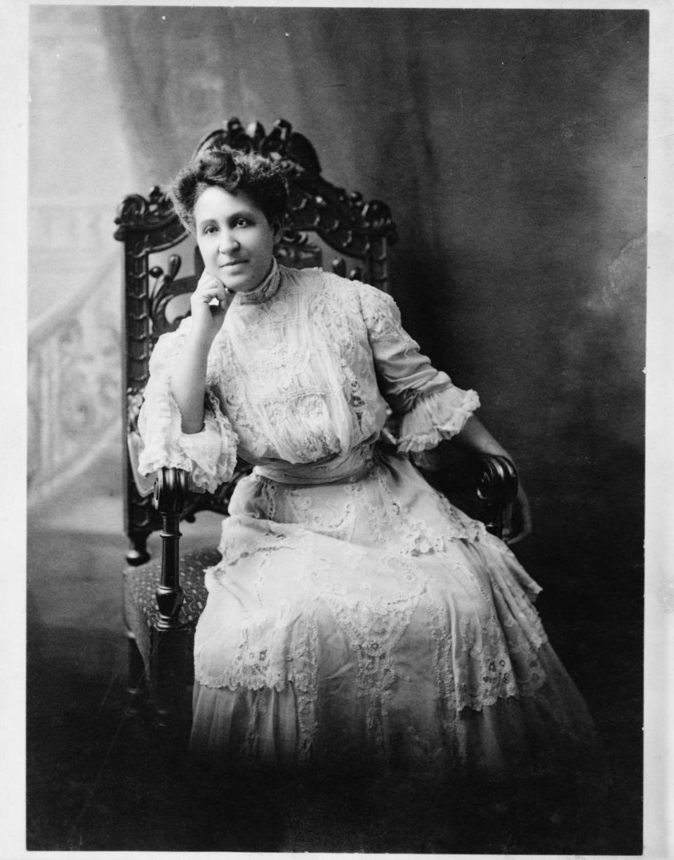 mary church terrell sits in a high backed chair in a lacy dress, she leans against on hand as her elbow rests on the armrest