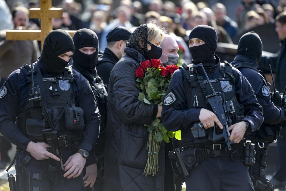 Armed Russian policemen guard an area during a funeral ceremony of slain Russian military blogger Vladlen Tatarsky, at the Troyekurovskoye cemetery in Moscow, Russia, Saturday, April 8, 2023. Tatarsky, known by his pen name of Maxim Fomin, was killed on Sunday, April 2, as he led a discussion at a riverside cafe in the historic heart of St. Petersburg, Russia's second-largest city. (Anton Velikzhanin, M24/Moscow News Agency via AP)