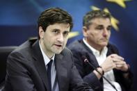 Newly appointed Finance Minister George Chouliarakis (L), flanked by his predecessor Euclid Tsakalotos, speaks during a handover ceremony at the Finance Ministry in Athens on August 28, 2015