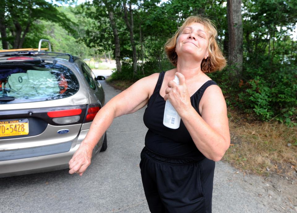 A visitor to Nickerson State Park in Brewster applies insect repellent in 2012.