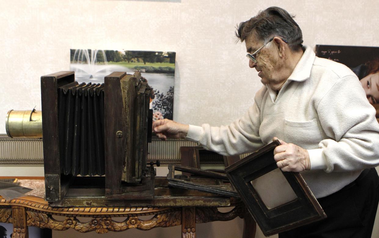 Ray Patnaude demonstrates how a 1907 Century No. 2 camera works at McDonald Studio in South Bend on Jan. 27, 2012. Patnaude has owned the photography business since 1946 as the studio celebrates its 150th year in business.