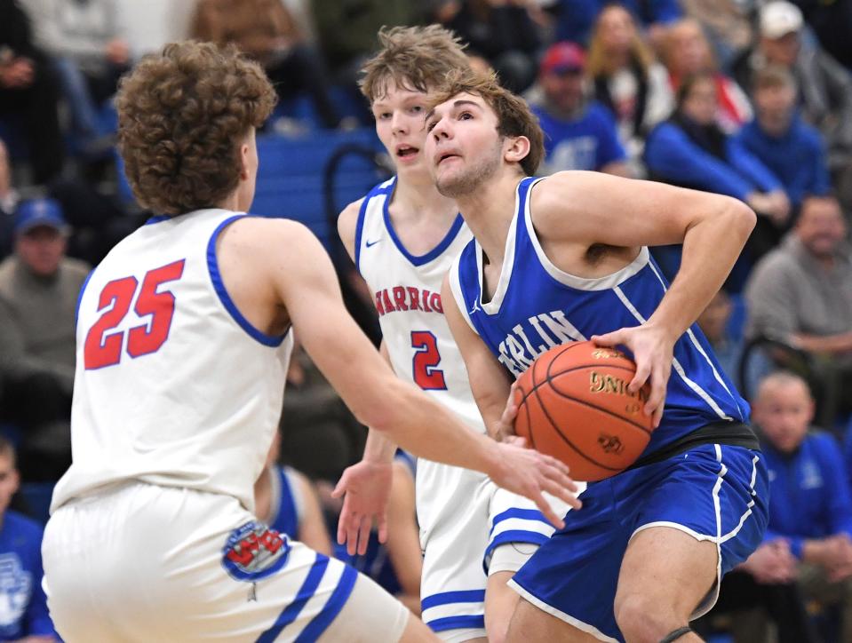 Berlin Brothersvalley's Haydon Hutzell looks to the basket between West Branch defenders Isaac Tiracorda (25) and Joel Evans (2) during the Inter-County Conference boys basketball championship, Feb. 17, in Claysburg.