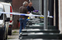 Investigators search rubbish bins behind a police cordon after three men were arrested in connection with an explosion on the London Underground, in Newport, Wales, Britain, September 20, 2017. REUTERS/Rebecca Naden