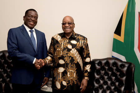South African President Jacob Zuma (R) shakes hands with Zimbabwe's former vice president Emmerson Mnangagwa in Pretoria, South Africa November 22, 2017. Ntswe Mokoena/Courtesy of GCIS/Handout via REUTERS