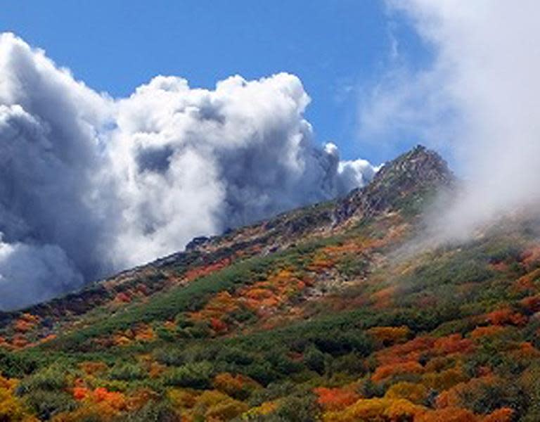 A picture taken by climber Keiji Aoki on September 27, 2014 shows white smoke rising from Mount Ontake as the volcano erupted