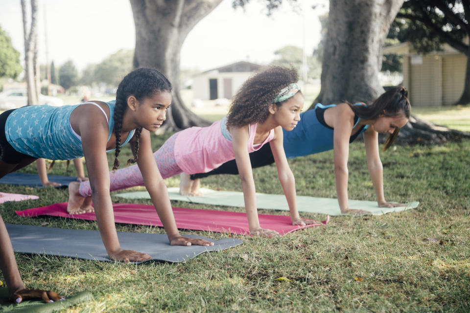 Little girls practicing the plank.