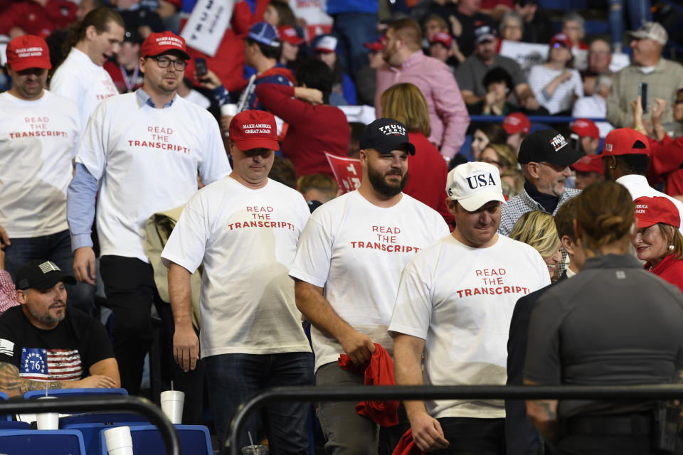 People wearing shirts with the words "Read the Transcript" arrive to attend a campaign rally with President Donald Trump in Lexington, Ky., Monday, Nov. 4, 2019. (AP Photo/Susan Walsh)