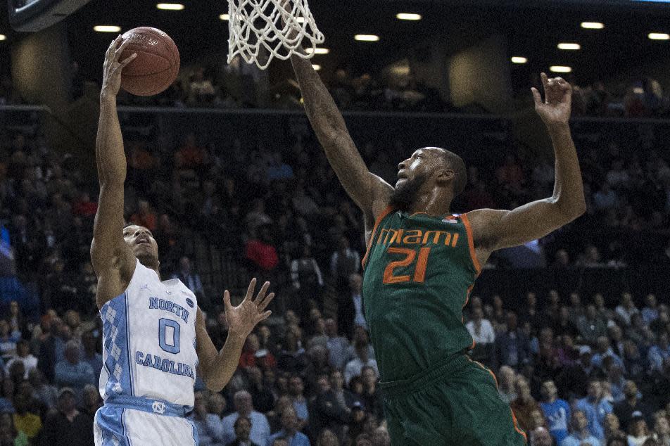 North Carolina guard Nate Britt (0) goes to the basket against Miami forward Kamari Murphy (21) during the second half of an NCAA college basketball game in the Atlantic Coast Conference tournament, Thursday, March 9, 2017, in New York. North Carolina won 78-53. (AP Photo/Mary Altaffer)