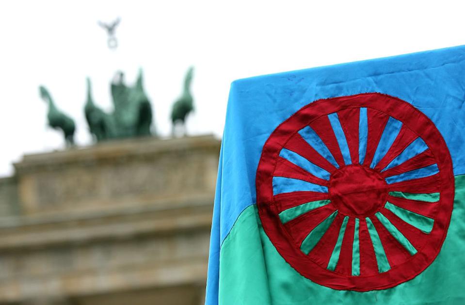 A Romani flag waves during an event on International Romani Day in front of Berlin’s Brandenburg Gate. <a href="https://www.gettyimages.com/detail/news-photo/romani-flag-hangs-at-a-pro-romani-demonstration-in-front-of-news-photo/468905978?adppopup=true" rel="nofollow noopener" target="_blank" data-ylk="slk:Adam Berry/Getty Images;elm:context_link;itc:0;sec:content-canvas" class="link ">Adam Berry/Getty Images</a>