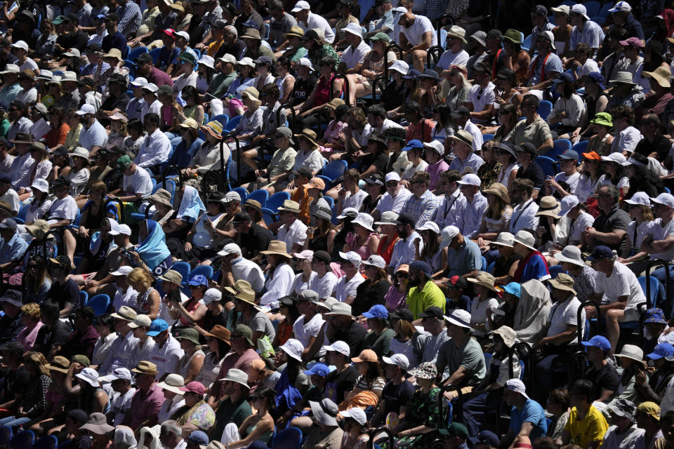 Spectators watch Stefanos Tsitsipas of Greece play Karen Khachanov of Russia during their semifinal at the Australian Open tennis championship in Melbourne, Australia, Friday, Jan. 27, 2023. (AP Photo/Aaron Favila)