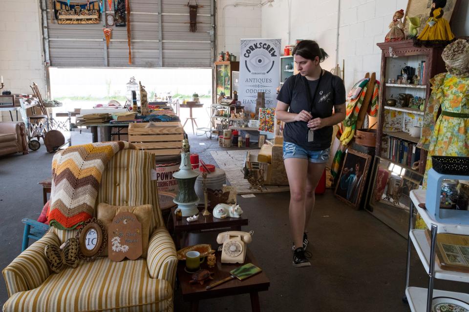 Erica Meny of Evansville explores the shipping garage at Corkscrew Curiosities in Henderson, Ky., Thursday, May 12, 2022. 