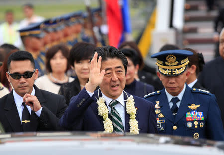 Japanese Prime Minister Shinzo Abe waves upon arrival for a state visit in metro Manila, Philippines January 12, 2017. REUTERS/Romeo Ranoco