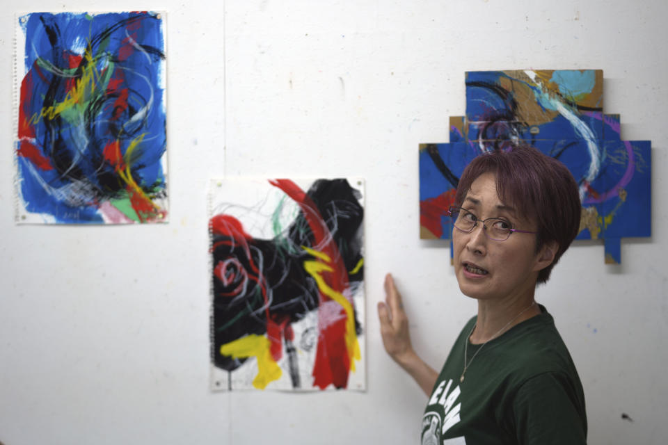 Japanese artist Miwako Sakauchi speaks about her art work for Art Exhibition "Declaration of the end of Olympic games" in Chiba near Tokyo Thursday, June 10, 2021. Polls have found an overwhelming majority of Japanese people are skeptical of the Tokyo Olympics being held this summer during a pandemic, but only a few have publicly marched to protest. But there are creative projects that are looking to protest the increasingly unpopular Tokyo Olympics, even as authorities seek to shut them down. (AP Photo/Eugene Hoshiko)