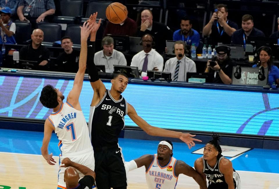 San Antonio Spurs French center #01 Victor Wembanyama and Oklahoma City Thunder's US power forward #07 Chet Holmgren reach for the ball during the NBA pre-season basketball game between San Antonio Spurs and Oklahoma City Thunder at Paycom Center arena in Oklahoma City, Oklahoma, on October 9, 2023. (Photo by TIMOTHY A. CLARY / AFP) (Photo by TIMOTHY A. CLARY/AFP via Getty Images)