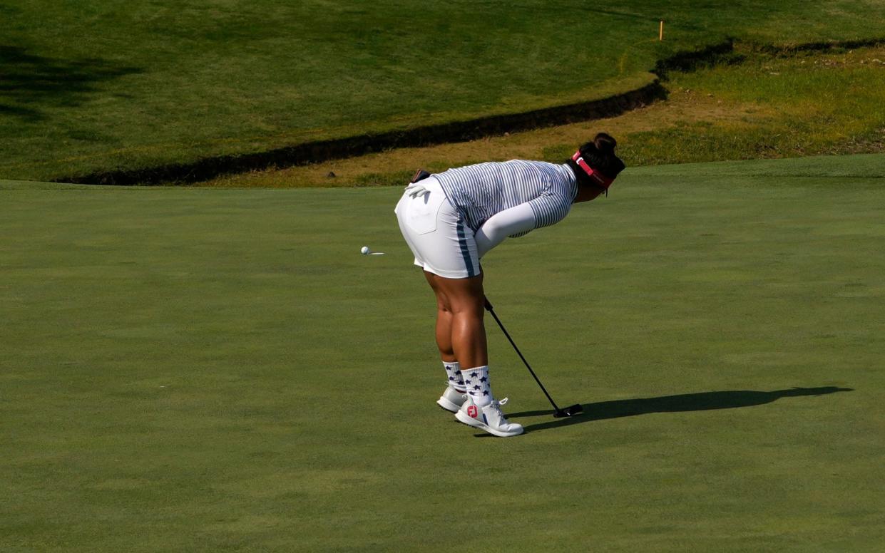 United States' Megan Khang watches as her putt hangs momentarily on the lip of the cup