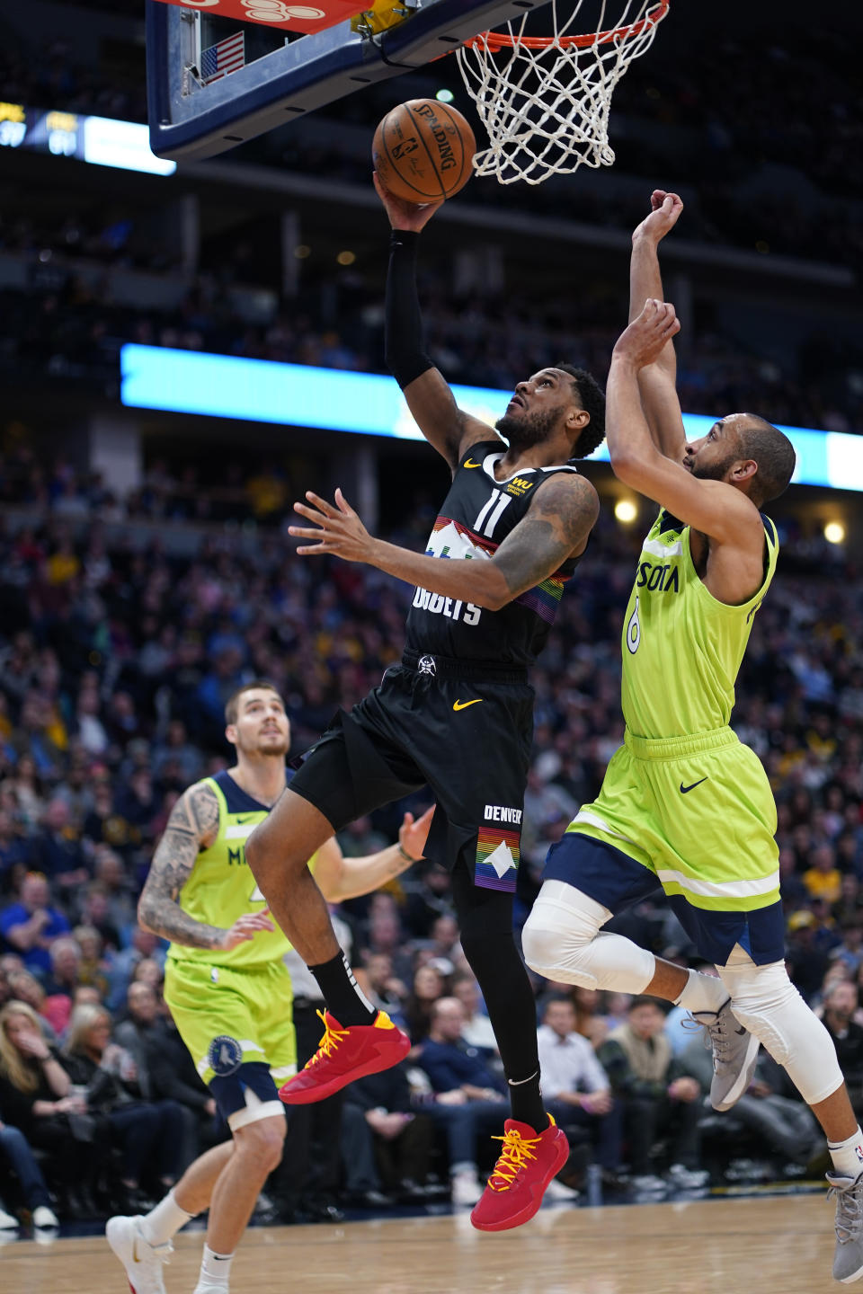 Denver Nuggets guard Monte Morris (11) goes up for a shot against Minnesota Timberwolves guard Jordan McLaughlin (6) during the third quarter of an NBA basketball game Sunday, Feb. 23, 2020, in Denver (AP Photo/Jack Dempsey)