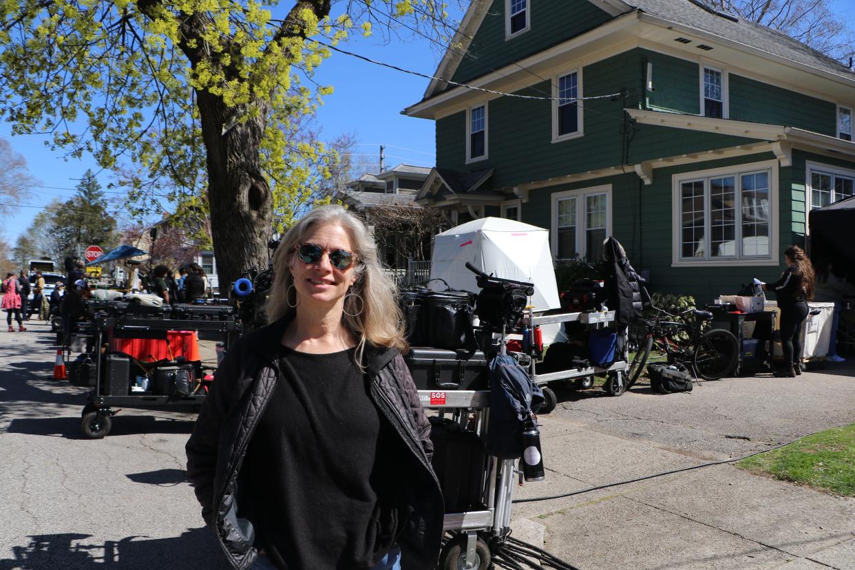 Lydia Breckon stands outside her home on Glenwood Avenue in Pawtucket while the cast of "Ella McCay" films inside her kitchen on Monday afternoon.