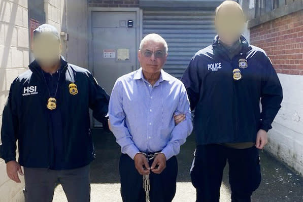 Roberto Antonio Garay Saravia was arrested Tuesday. (Officers' faces blurred by source.) (ICE)