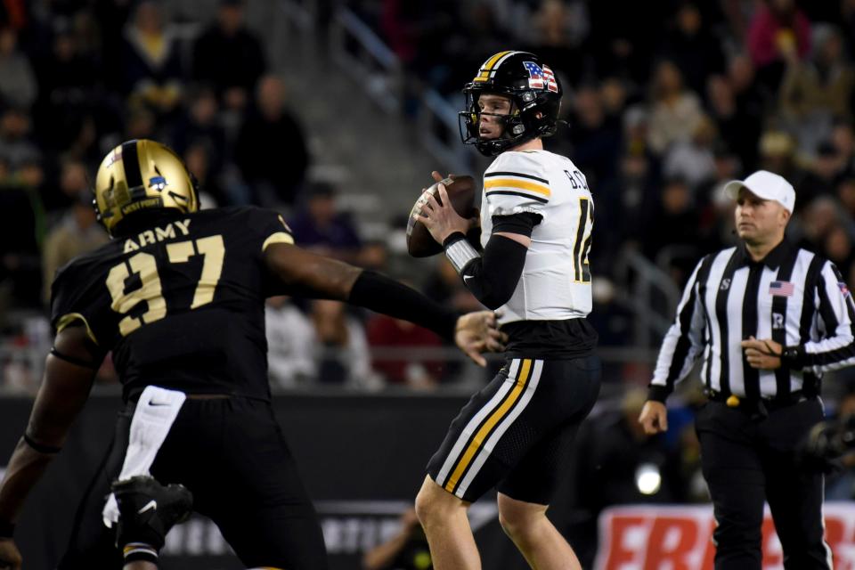 Missouri quarterback Brady Cook drops back to pass under pressure from Army defensive lineman Kwabena Bonsu (97) in the first half against Army in the Armed Forces Bowl on Dec. 23 in Fort Worth, Texas.