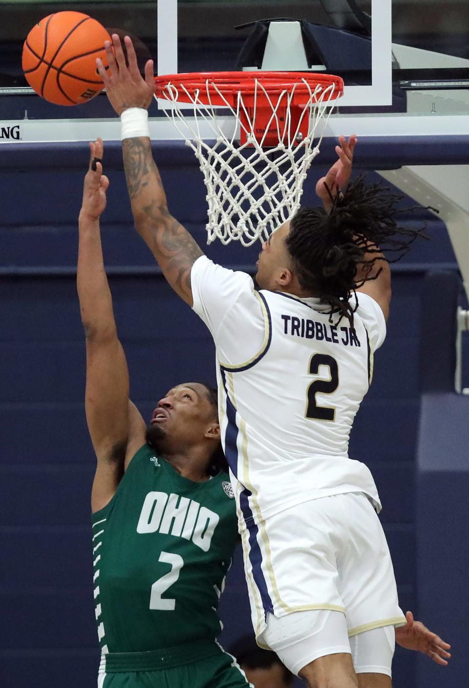 Akron guard Greg Tribble blocks the shot of Ohio's Miles Brown during the second half Tuesday in Akron.