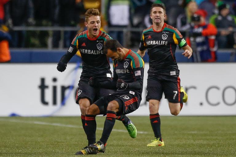 Juninho (C) of the Los Angeles Galaxy celebrates with teammates after scoring a goal against the Seattle Sounders FC during the Western Conference 2nd leg Final at CenturyLink Field, in Seattle, Washington, on November 30, 2014