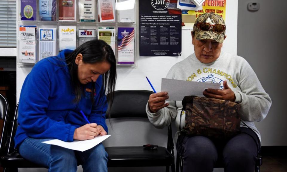 Members of the Standing Rock Sioux Tribe in Fort Yates fill out forms to receive new tribal IDs with street addresses.