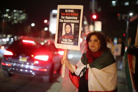 Iranian expatriate Roxanne Ganji holds a sign at a protest in Los Angeles, California U.S. January 3, 2018. Picture taken January 3, 2018. REUTERS/Lucy Nicholson