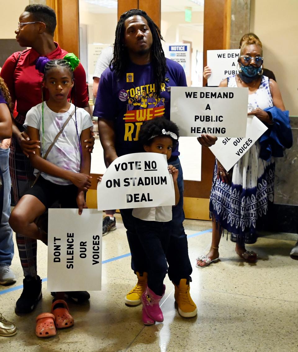 Stand Up Nashville demonstrators outside the Metro Council chambers on Tuesday, April 18, 2023, in Nashville, Tenn. The group could not get into the council meeting because it was filled with Tennessee Titans stadium proponents. Stand Up Nashville protestors wanted to call attention to gun violence, healthcare issues and workers’ rights and ask the Metro Council to have a public hearing about the issues.