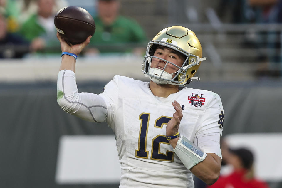 Notre Dame quarterback Tyler Buchner (12) throws a pass during the second quarter of the Gator Bowl NCAA college football game against South Carolina on Friday, Dec. 30, 2022, in Jacksonville, Fla. (AP Photo/Gary McCullough)