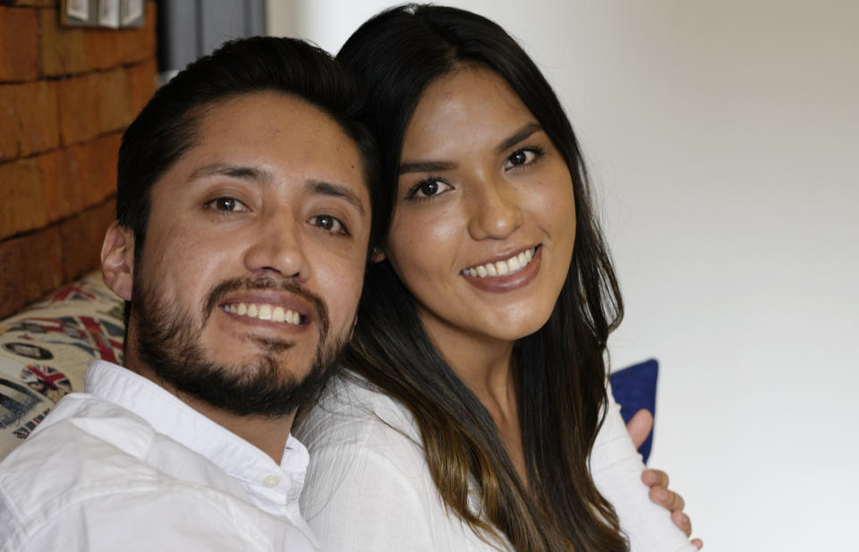 Doctor David Vallejo and his fiancee Doctor Mavelin Bonilla pose for a photo at home in Quito, Ecuador, Wednesday, June 9, 2021. Doctor Vallejo and Doctor Bonilla suspended their wedding in order to tend to COVID-19 patients and in the process Vallejo got sick himself with the disease, ending up in an ICU for several days. (AP Photo/Dolores Ochoa)