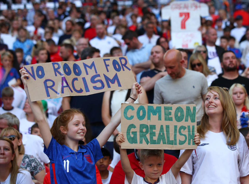 <p>LONDON, ENGLAND - SEPTEMBER 05: Children show messages of support for England playerJack Grealish alongside anti-racism slogans during the 2022 FIFA World Cup Qualifier between England and Andorra at Wembley Stadium on September 5, 2021 in London, England. (Photo by Marc Atkins/Getty Images)</p>
