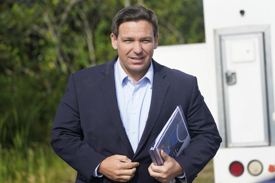 Florida Gov. Ron DeSantis arrives at a news conference, Tuesday, at which he insisted that the COVID-19 surge in the state will be short-lived.