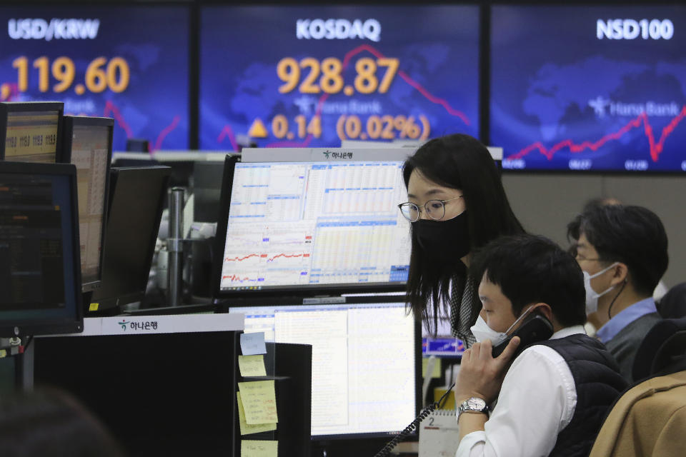 Currency traders watch monitors at the foreign exchange dealing room of the KEB Hana Bank headquarters in Seoul, South Korea, Monday, Feb. 1, 2021. Asian stock markets gained Monday after coronavirus vaccine maker AstraZeneca agreed to increase supplies to Europe amid rising worries about the disease. (AP Photo/Ahn Young-joon)