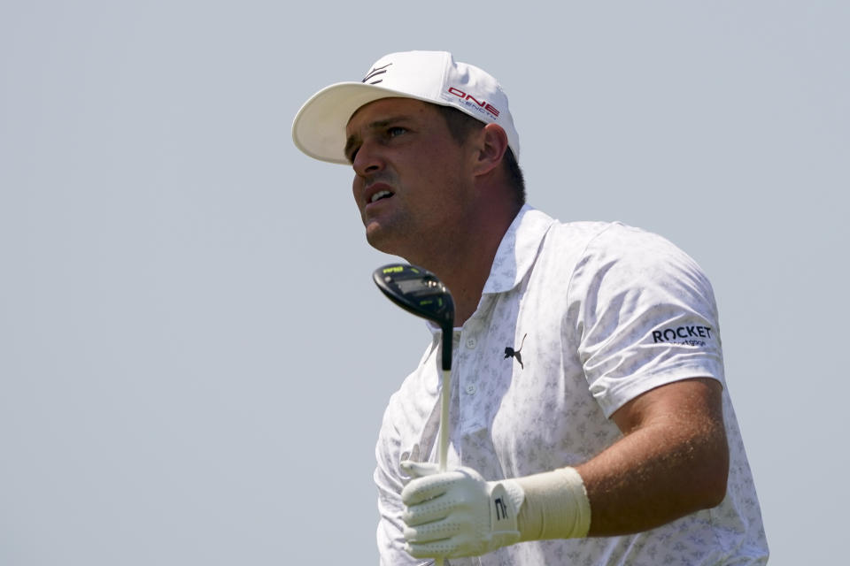 Bryson Dechambeau watches his tee shot on the 10th hole during a practice round for the PGA Championship golf tournament, Wednesday, May 18, 2022, in Tulsa, Okla. (AP Photo/Matt York)