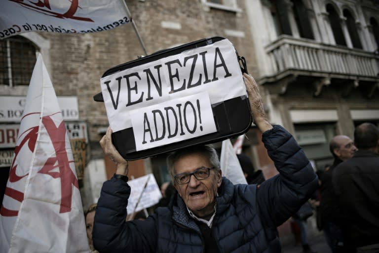 Farewell, Venice: Demonstrators wielded luggage plastered with slogans at a rally last year to protest at a surge in tourism that has caused the city's year-round population to plummet