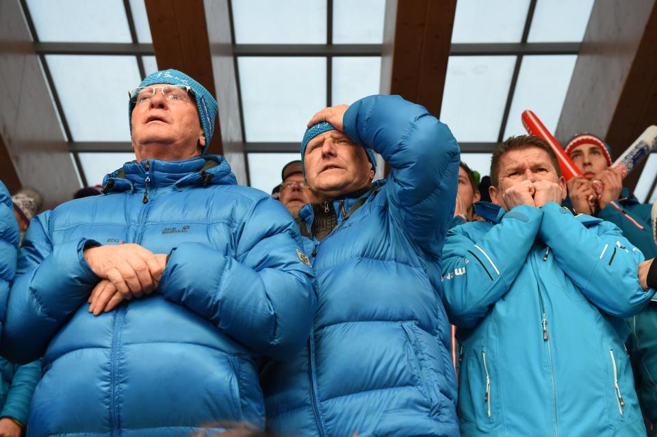 Fans of Germany's Sascha Benecken and Toni Eggert watch as the team races in the Luge Doubles Run 1 at the Sanki Sliding Center during the Sochi Winter Olympics on February 12, 2014. 