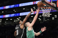 Boston Celtics guard Payton Pritchard drives against Brooklyn Nets forward Royce O'Neale (00) during the first half of an NBA basketball game, Sunday, Dec. 4, 2022, in New York. (AP Photo/Jessie Alcheh)