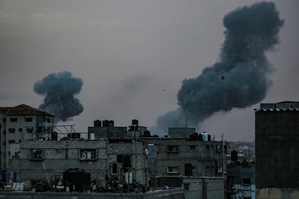 Smoke rises above damaged buildings (AFP - Getty Images)