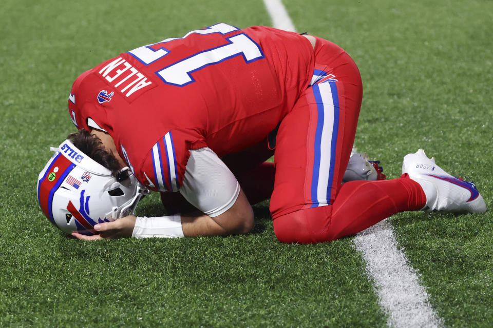 Buffalo Bills quarterback Josh Allen clutches his head after taking a hit from New York Giants linebacker Bobby Okereke during the first half of an NFL football game in Orchard Park, N.Y., Sunday Oct. 15, 2023. (AP Photo/ Jeffrey T. Barnes)