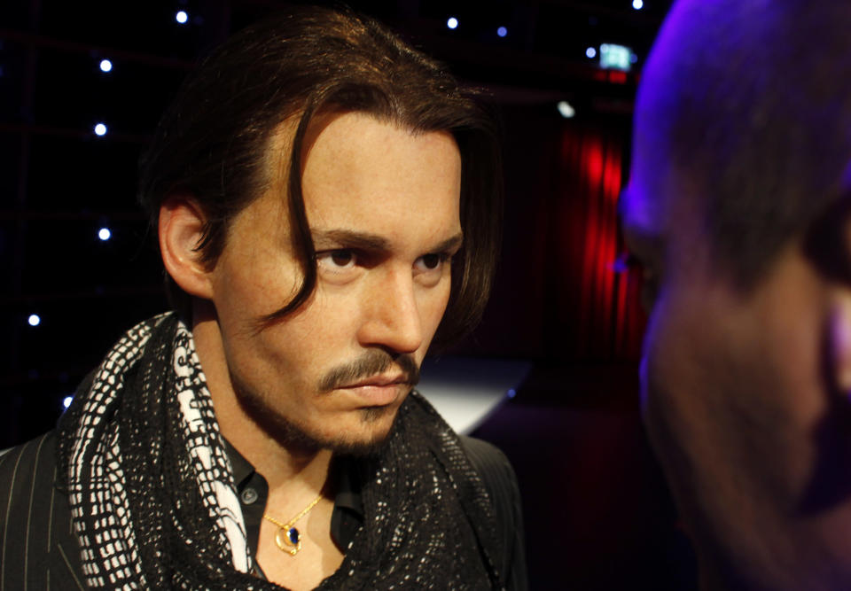 A man looks at a wax figure of actor Johnny Depp at the opening of Madame Tussauds in Vienna March 31, 2011. Sixty-three wax figures can be seen from April 1 at Vienna's Madame Tussauds, which is the eleventh branch of the popular tourist attraction in the world. REUTERS/Herwig Prammer