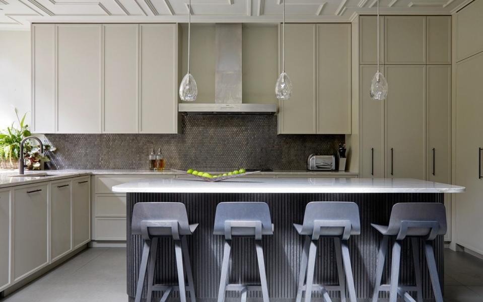 If the cabinets stop short of the ceiling it will make the space feel smaller