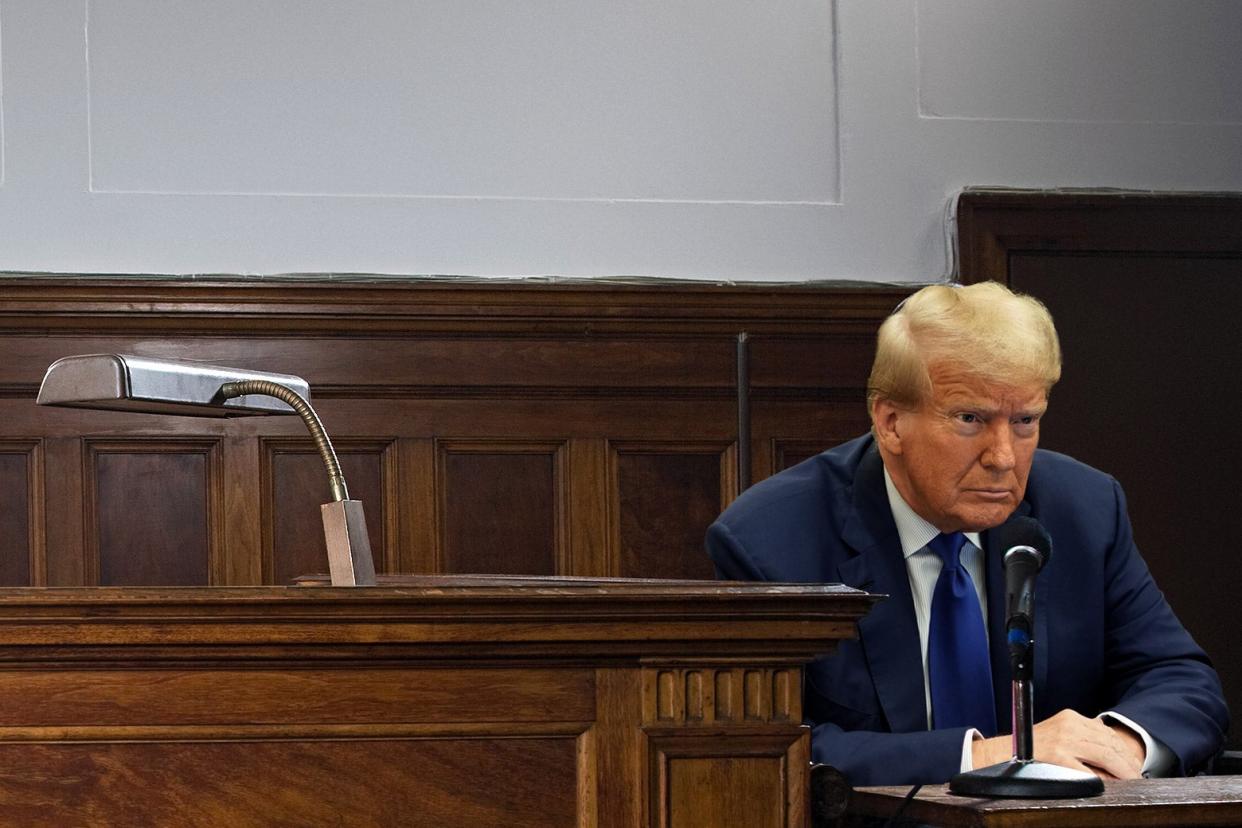 Donald Trump, mouth closed, at a witness stand with a mic in front of him.