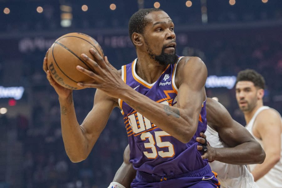 Phoenix Suns' Kevin Durant (35) drives to the basket in front of Cleveland Cavaliers' Caris LeVert during the first half of an NBA basketball game in Cleveland, Monday, March 11, 2024. (AP Photo/Phil Long)