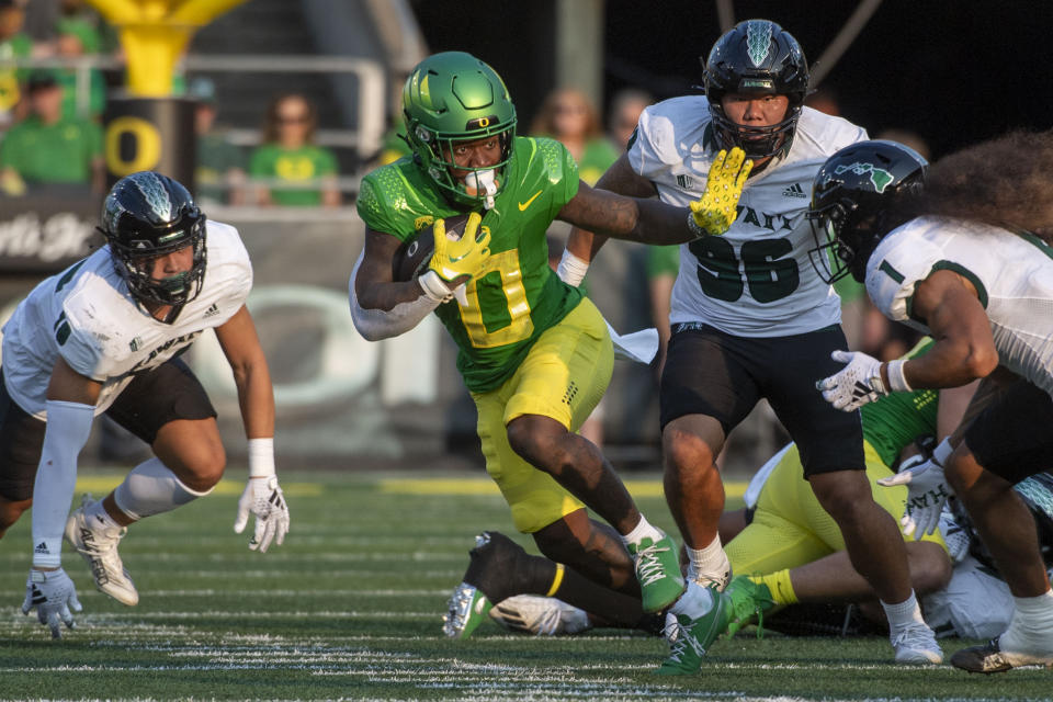 Oregon running back Bucky Irving (0) makes a cut past Hawaii defensive back Peter Manuma (1) during the first half of an NCAA college football game Saturday, Sept. 16, 2023, in Eugene, Ore. (AP Photo/Andy Nelson)