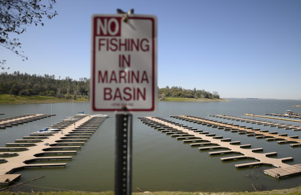 A sign stands in the Browns Ravine Cove area of Folsom Lake, in Folsom, Calif., on Sunday, March 26, 2023. Months of winter storms have replenished California's key reservoirs after three years of punishing drought. (AP Photo/Josh Edelson)