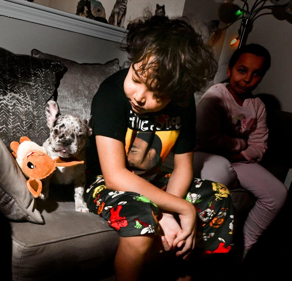 Jayden Wilsey, 13, of Mashpee sits with his new French bulldog Floki. Jayden's diagnosis of sickle cell beta thalassemia, a rare form of the disease, has come with many painful days and some school absences, according to his father Aubrey Wilsey. "We are hoping to get him back soon," Wilsey said.
